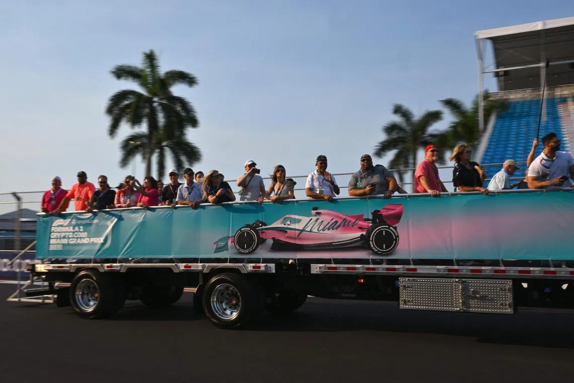 Visitors riding on a truck on the race track at the Miami International Autodrome ahead of the Miami Grand Prix in Florida.