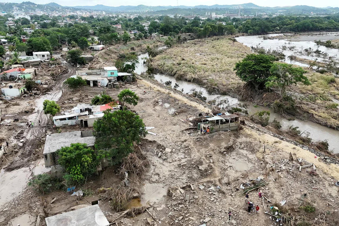 FILE PHOTO: A drone view shows fallen trees, debris and damaged houses amid muddy floodwater after a river overflowed following torrential rains, in Poza Rica, Mexico, October 15, 2025.REUTERS/Henry Romero/File Photo