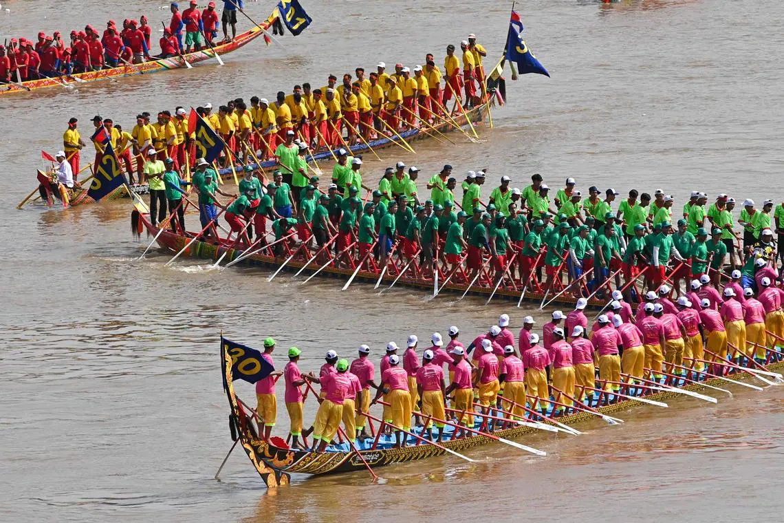 Participants row their dragon boats during the Cambodian Water Festival on the Tonle Sap river in Phnom Penh on Nov 28.