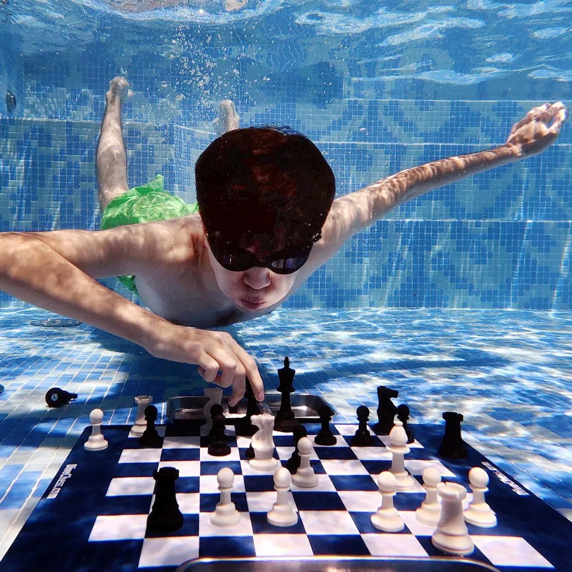 FILE PHOTO: Chess - Grand Masters compete in Diving Chess Competition - Silo Hotel, Cape Town, South Africa - December 4, 2025 Uzbekistan's Javokhir Sindarov in action against Hans Niemann of the U.S. REUTERS/Esa Alexander/File Photo