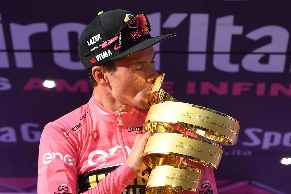 Visma's Primoz Roglic kisses the trophy after winning the Giro d'Italia.