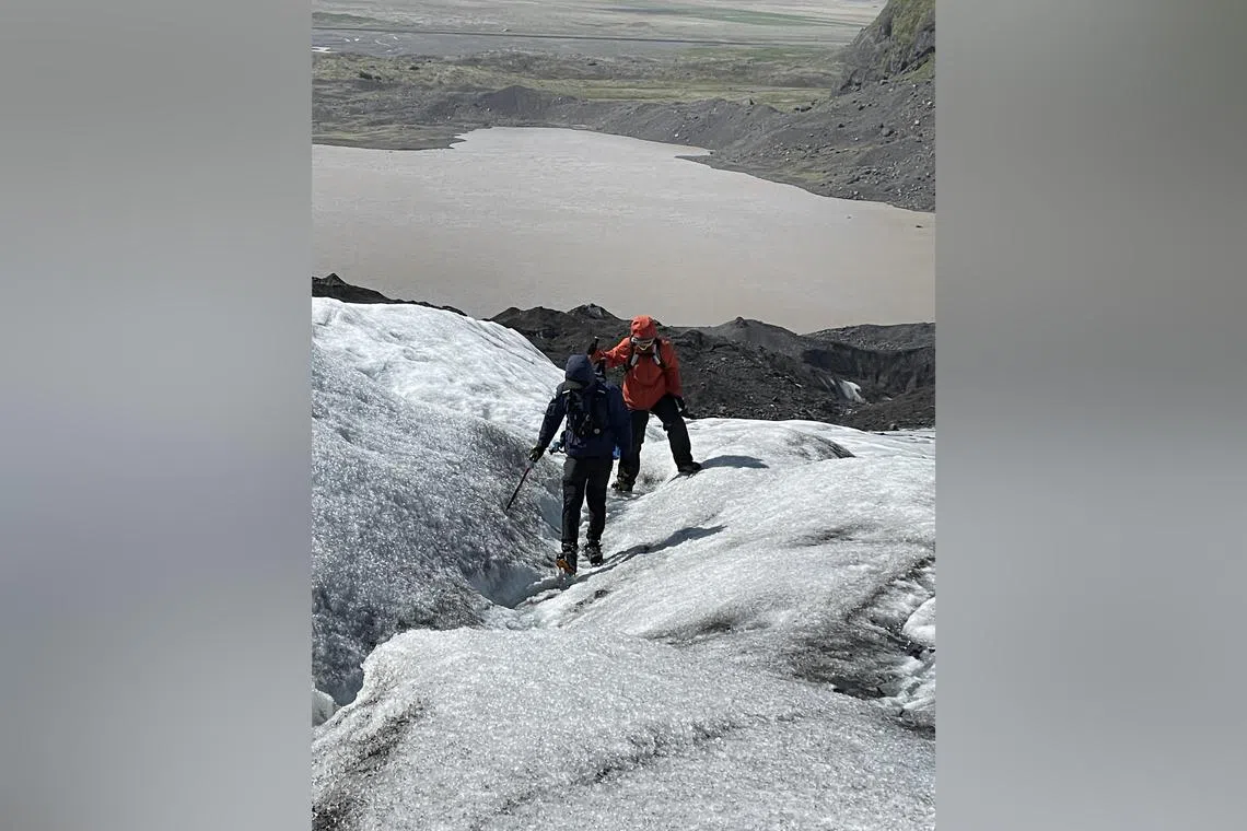 The writer struggling through her glacier trek with the guide ahead of her. 