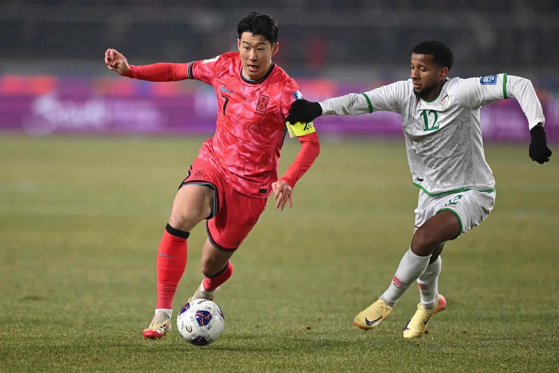 South Korea's Son Heung-min competes for the ball with Oman's Abdullah Al-Harthi during the World Cup 2026 Asian qualifier match.