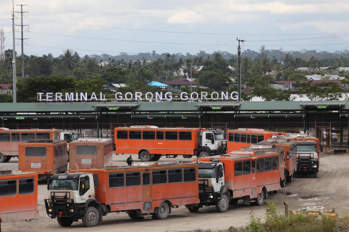 FILE PHOTO: Vehicles used for transporting workers to the Grasberg copper mine operated by Freeport McMoRan Inc are seen at the Gorong-Gorong terminal in Timika, Mimika, Papua province, Indonesia on November 16, 2017. Picture taken November 16, 2017. REUTERS/Muhammad Yamin/File Photo