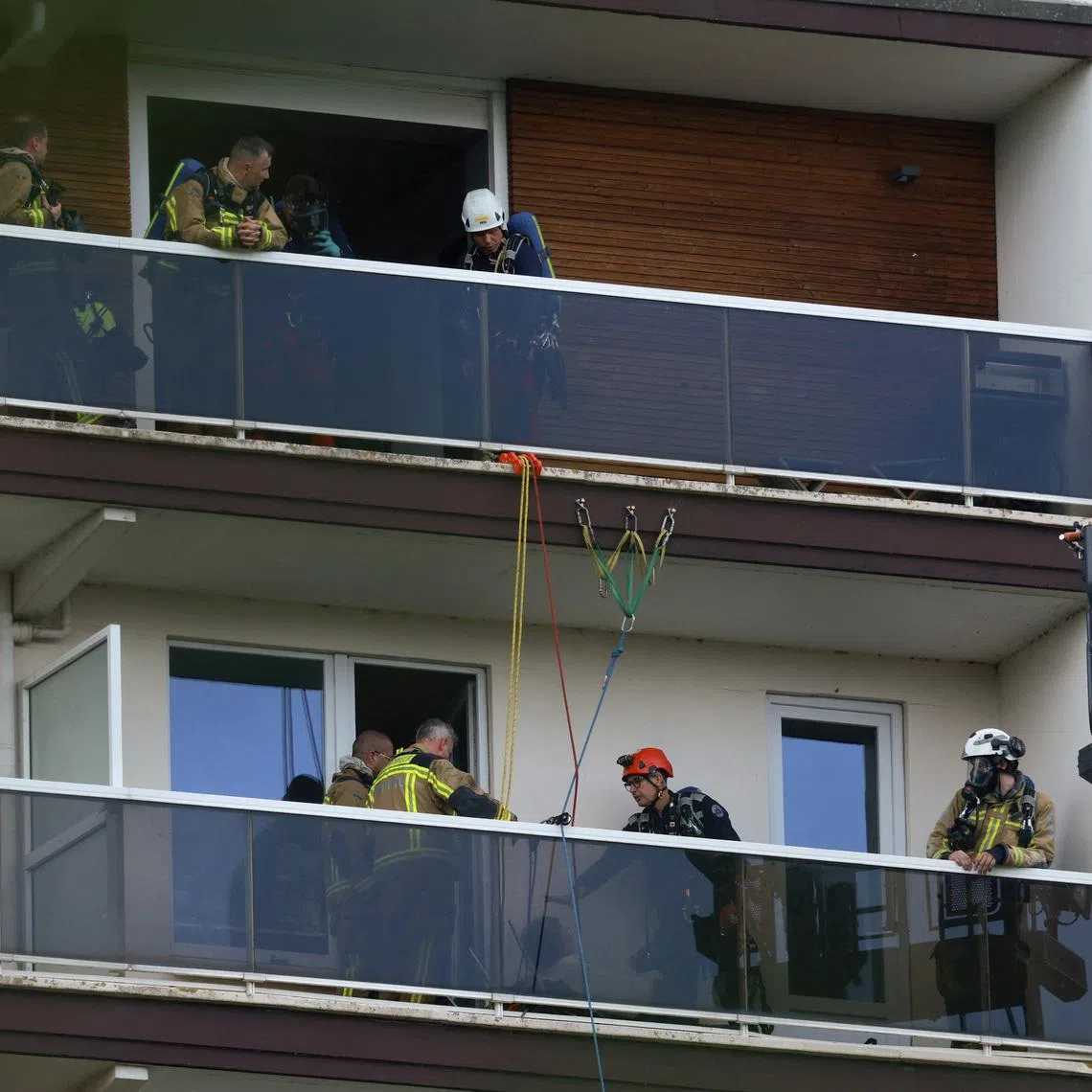 Rescuers work at the site of a fire in a housing building in Antwerp, Belgium, July 1.