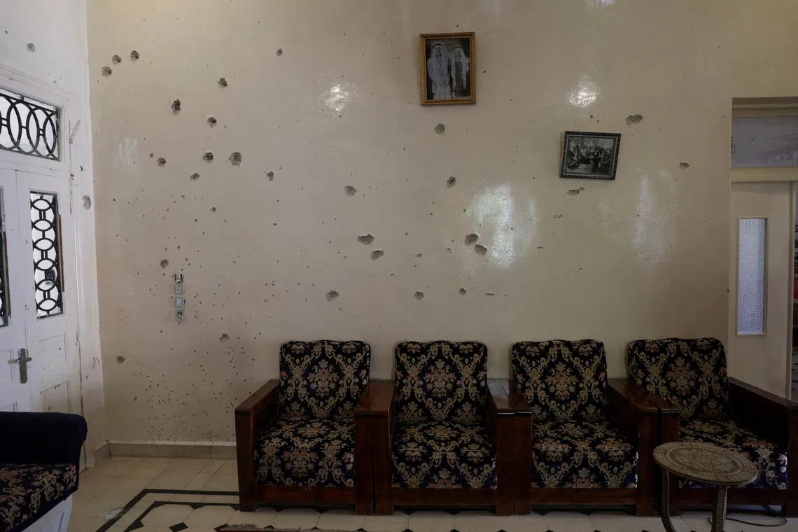 FILE PHOTO: A wall is pockmarked by bullet holes inside the Saraya family house, following sectarian violence in Syria's Sweida province, where government forces were sent to quell local clashes between Druze armed factions and Bedouin tribal fighters, in the predominantly Druze city of Sweida, Syria, July 25, 2025. REUTERS/Khalil Ashawi/File Photo