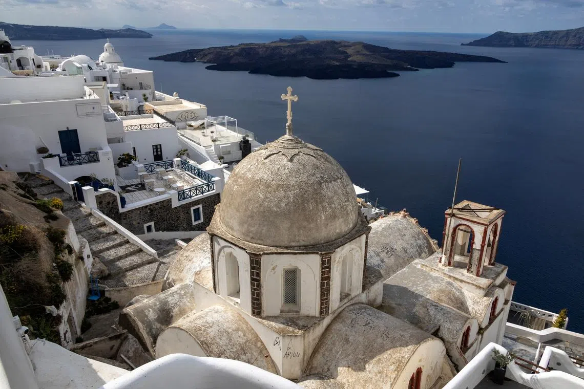 The volcanic islet of Nea Kameni, seen from the village of Fira, as the seismic activity continues, on the island of Santorini, Greece, Feb 19, 2025. 