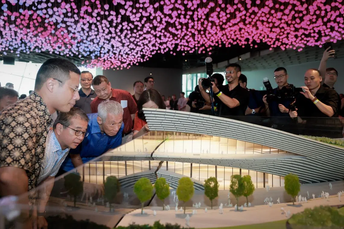 Senior Minister Lee Hsien Loong, Minister for Culture, Community and Youth Edwin Tong and Minister for National Development Desmond Lee looking at a model of the Founders’ Memorial at the groundbreaking ceremony on June 5, 2024.