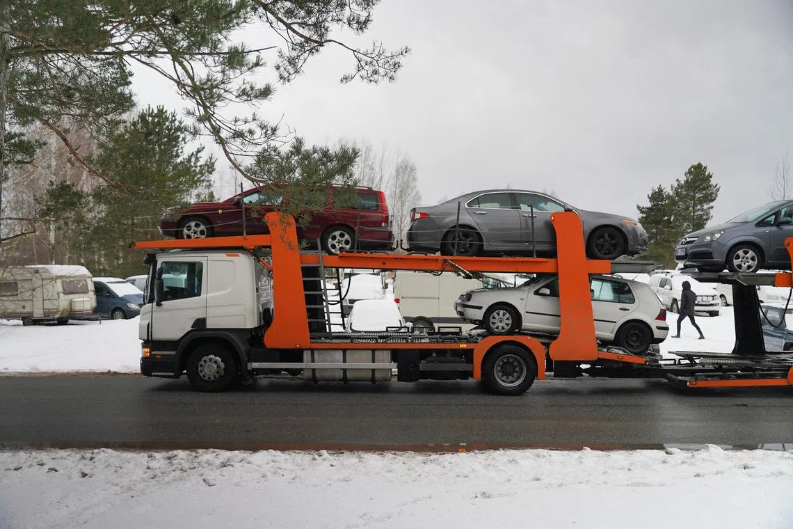 Seven cars were driven in a snowstorm onto a trailer and out of a state impound lot on Wednesday, destined for Ukraine.