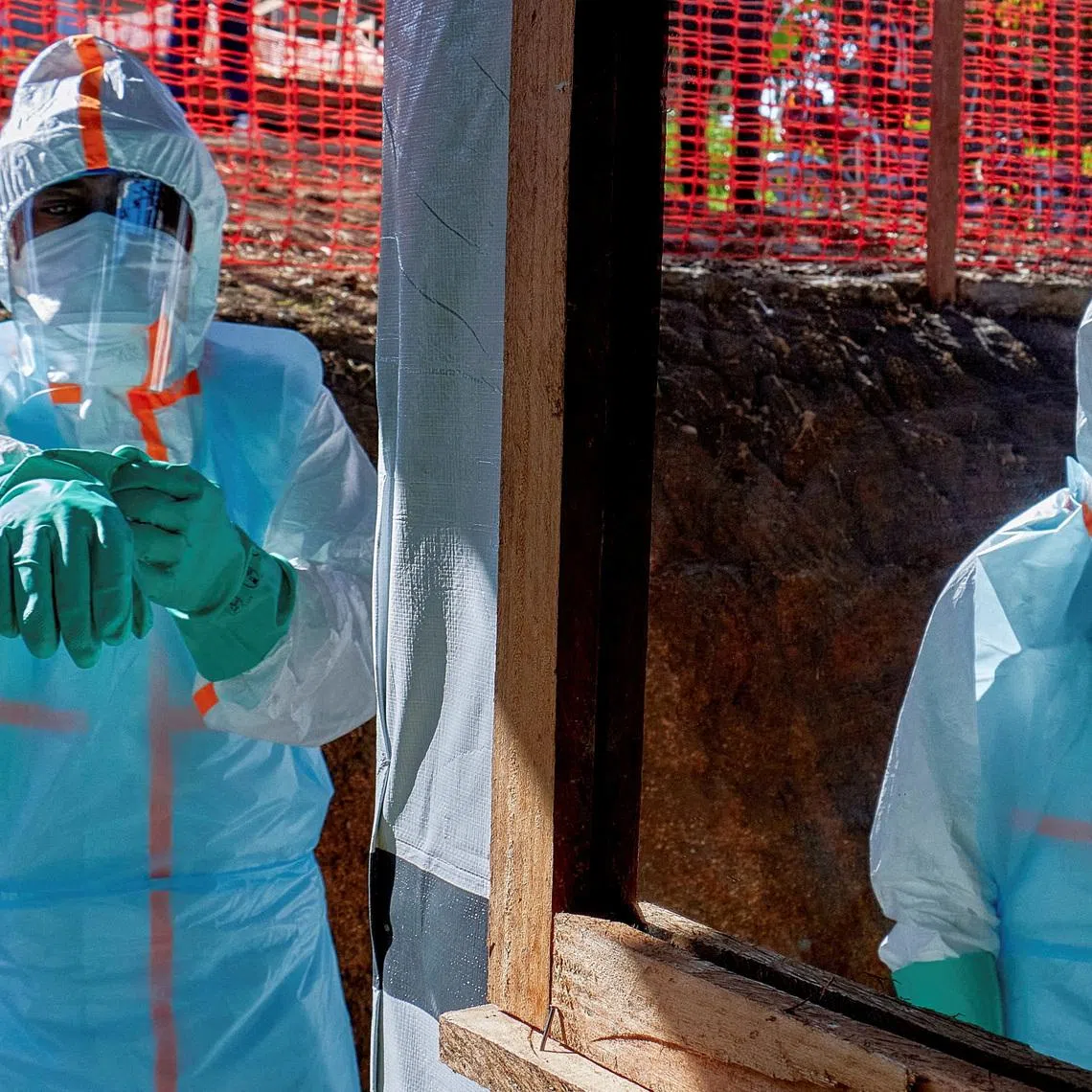 FILE PHOTO: Health workers get dressed in personal protective equipment (PPE) at the Evangelical Medical Center, one of the facilities at the forefront of the response to the Ebola outbreak, as agencies intensify efforts to contain a new Ebola outbreak caused by the Bundibugyo virus strain, in Bunia, Ituri province, Democratic Republic of Congo, May 31, 2026. REUTERS/Gradel Muyisa Mumbere/File Photo