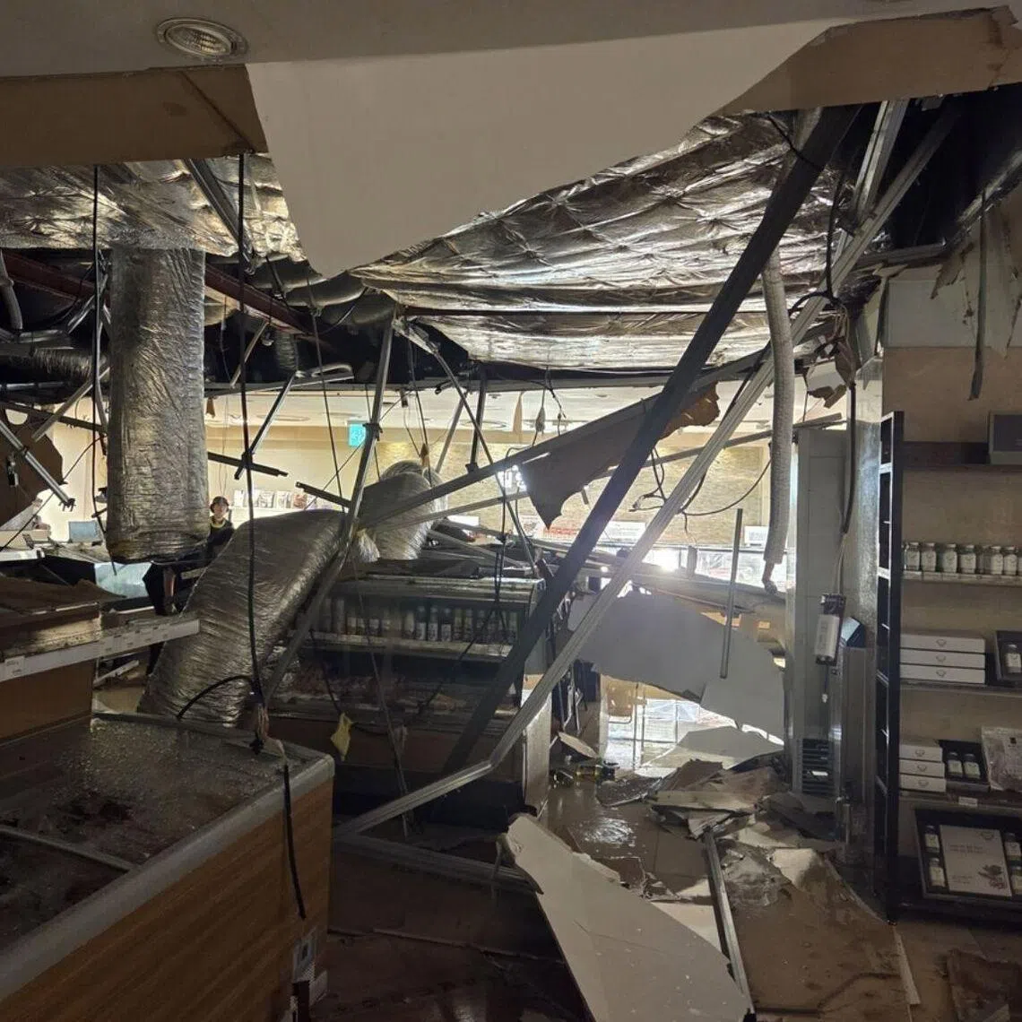A section of the first basement floor ceiling collapsed, causing water to gush from above and flood the area below.