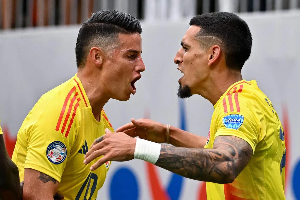 Jun 24, 2024; Houston, TX, USA; Colombia full-back Daniel Munoz (21) is congratulated by midfielder James Rodriguez (10) after scoring a goal during the first half against Paraguay at NRG Stadium. Mandatory Credit: Maria Lysaker-USA TODAY Sports