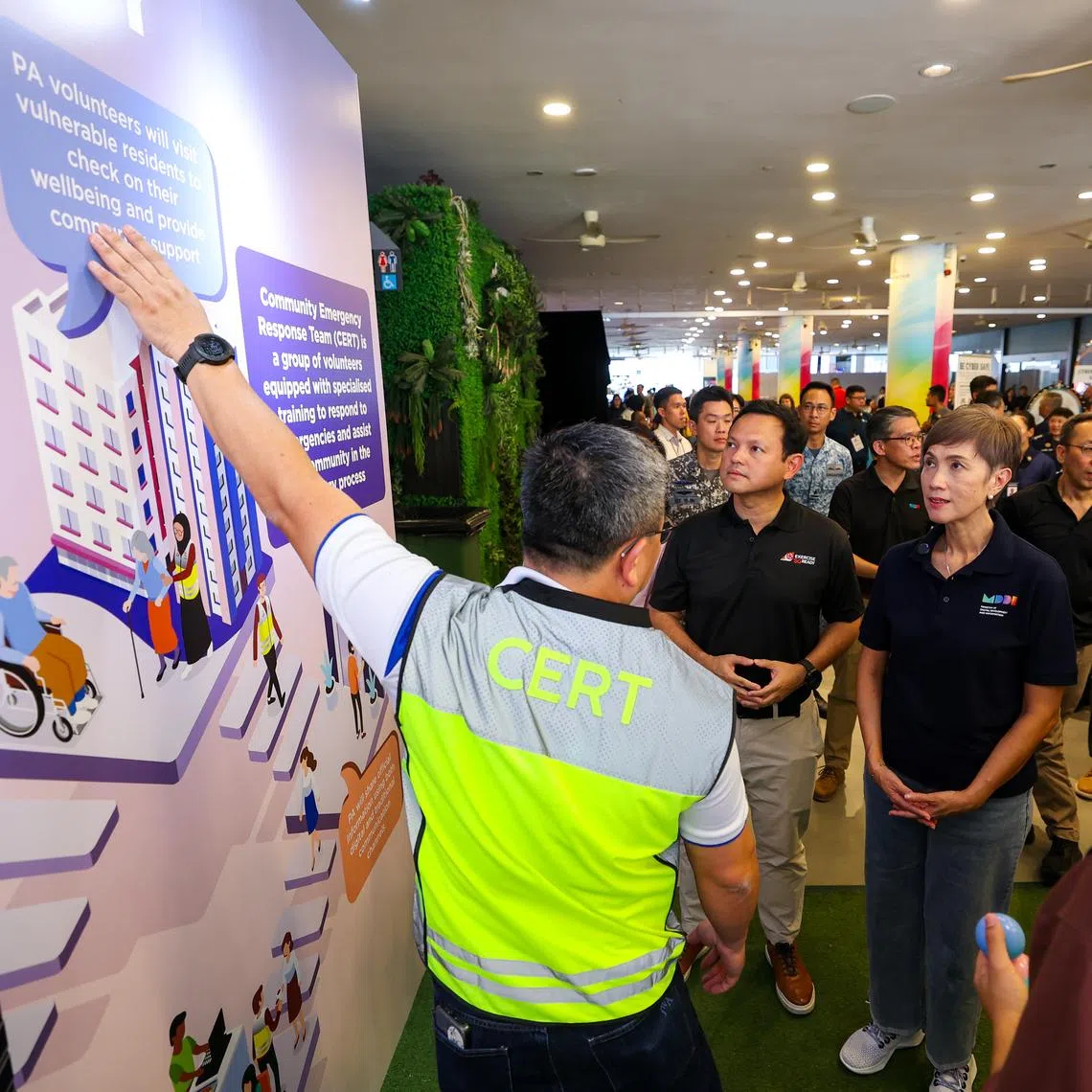 Minister for Digital Development and Information Josephine Teo (second from right) and Senior Minister of State for Sustainability and the Environment Zaqy Mohamad (centre) during the Total Defence Commemoration Event.