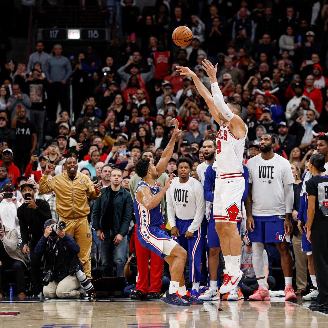 Chicago Bulls centre Nikola Vucevic shooting and scoring a game-winning three-pointer against Philadelphia 76ers guard Quentin Grimes during the second half of their 113-111 NBA home win at United Centre on Nov 4, 2025.