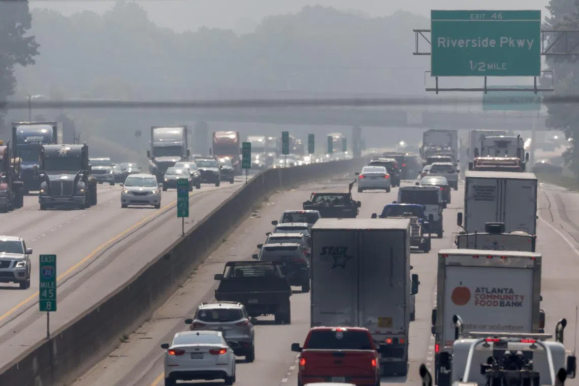 Commuters negotiate the hazy conditions during the morning rush hour traffic along Interstate 20 on the west side of Atlanta, Georgia.