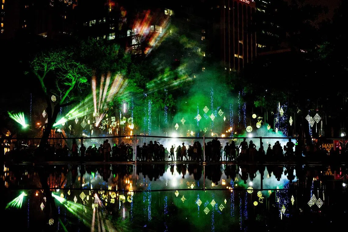 People visit a Christmas light show in Makati City, Metro Manila, Philippines, Dec 13, 2022. 