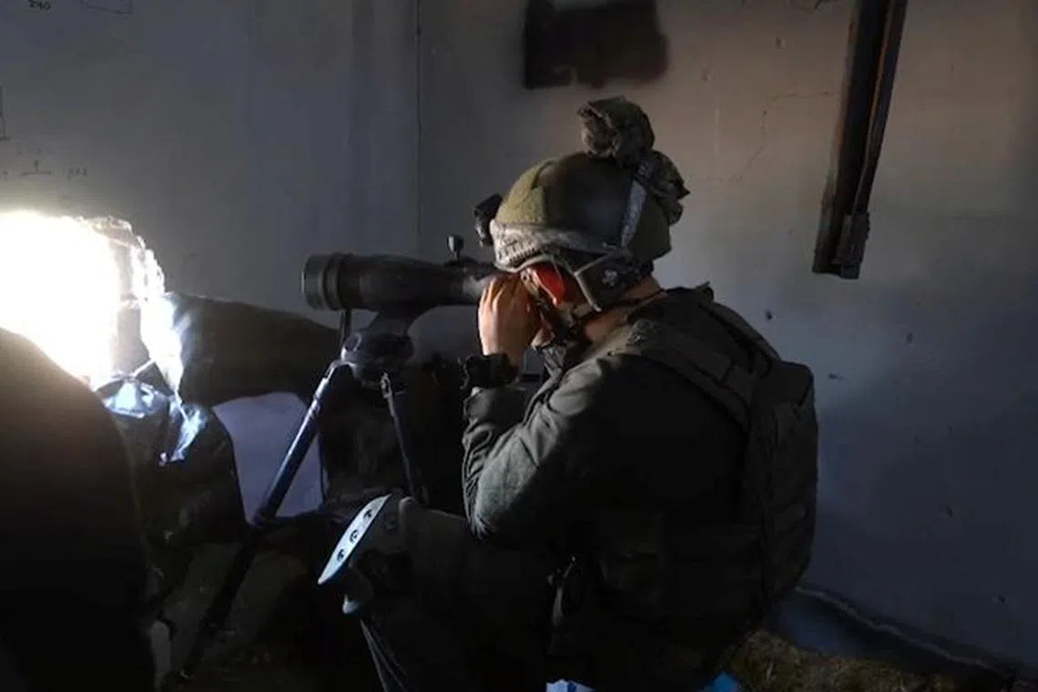 A member of the Israeli army operates in a location given as Gaza, amid the ongoing conflict between Israel and the Palestinian Islamist group Hamas, in this still image obtained from a handout video released December 3, 2023.    Israel Defense Forces/Handout via REUTERS