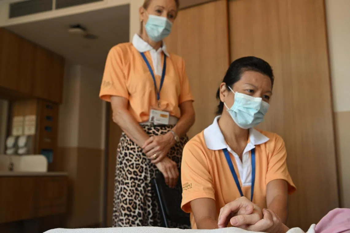 (Posed photo) Volunteers under Noda@Assisi, Daphne Lim, 50, (seated) and Eva Maitra, 67, take turns on the vigil to keep the dying patient company until the end.