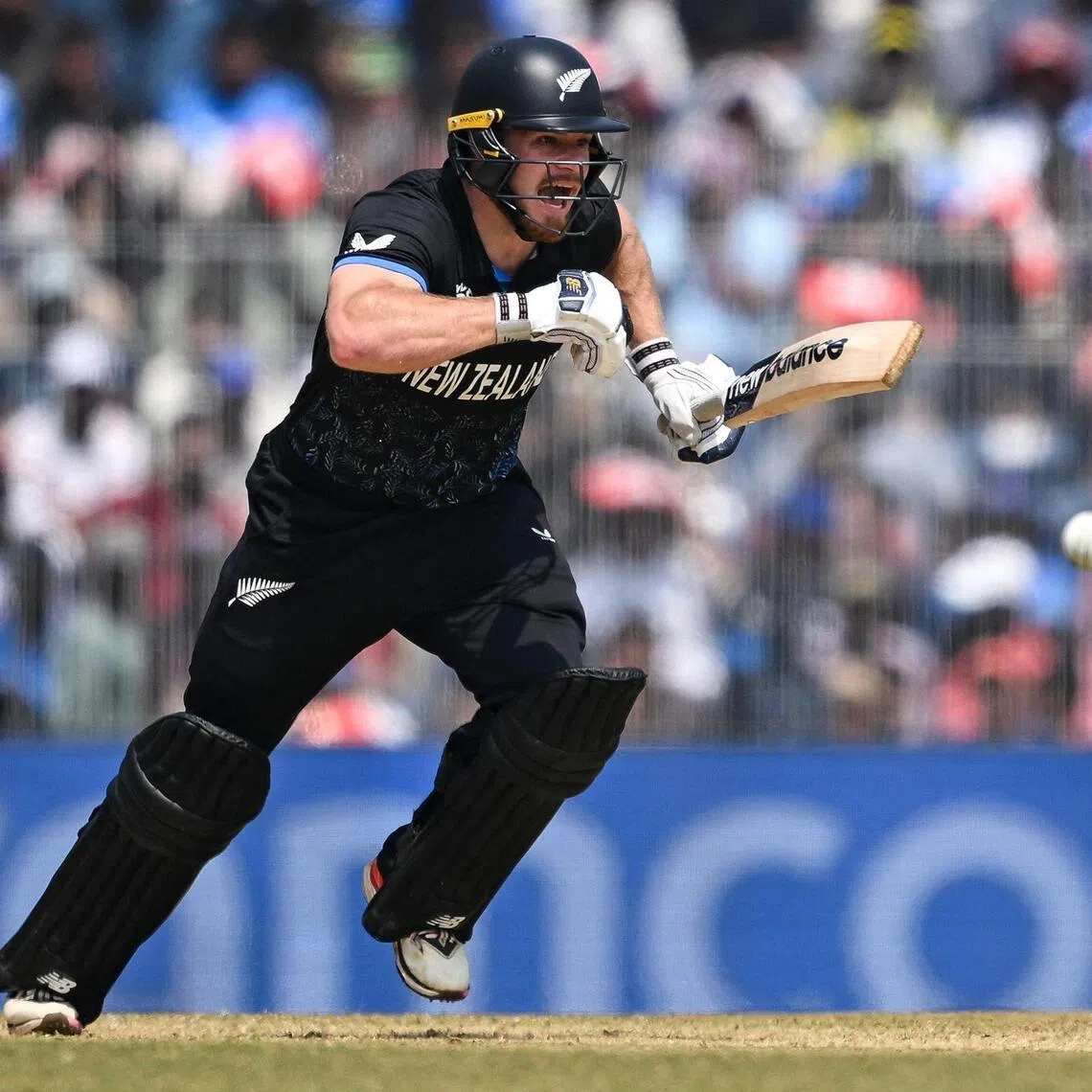 New Zealand's Glenn Phillips runs between the wickets after playing a shot in the ICC Men's T20 Cricket World Cup group-stage match against Afghanistan at the M.A. Chidambaram Stadium in Chennai on Feb 8, 2026.