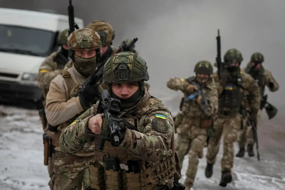 Ukrainian servicemen attend joint drill, near the border with Belarus, on Jan 11, 2022.