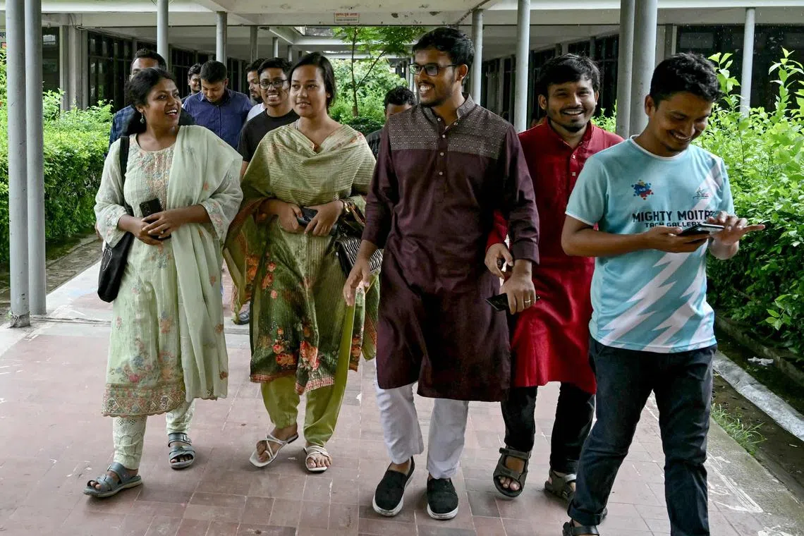 Bangladeshi political science student Nusrat Tabassum (left) speaks with batchmates at the Dhaka University in the capital on Aug 11.