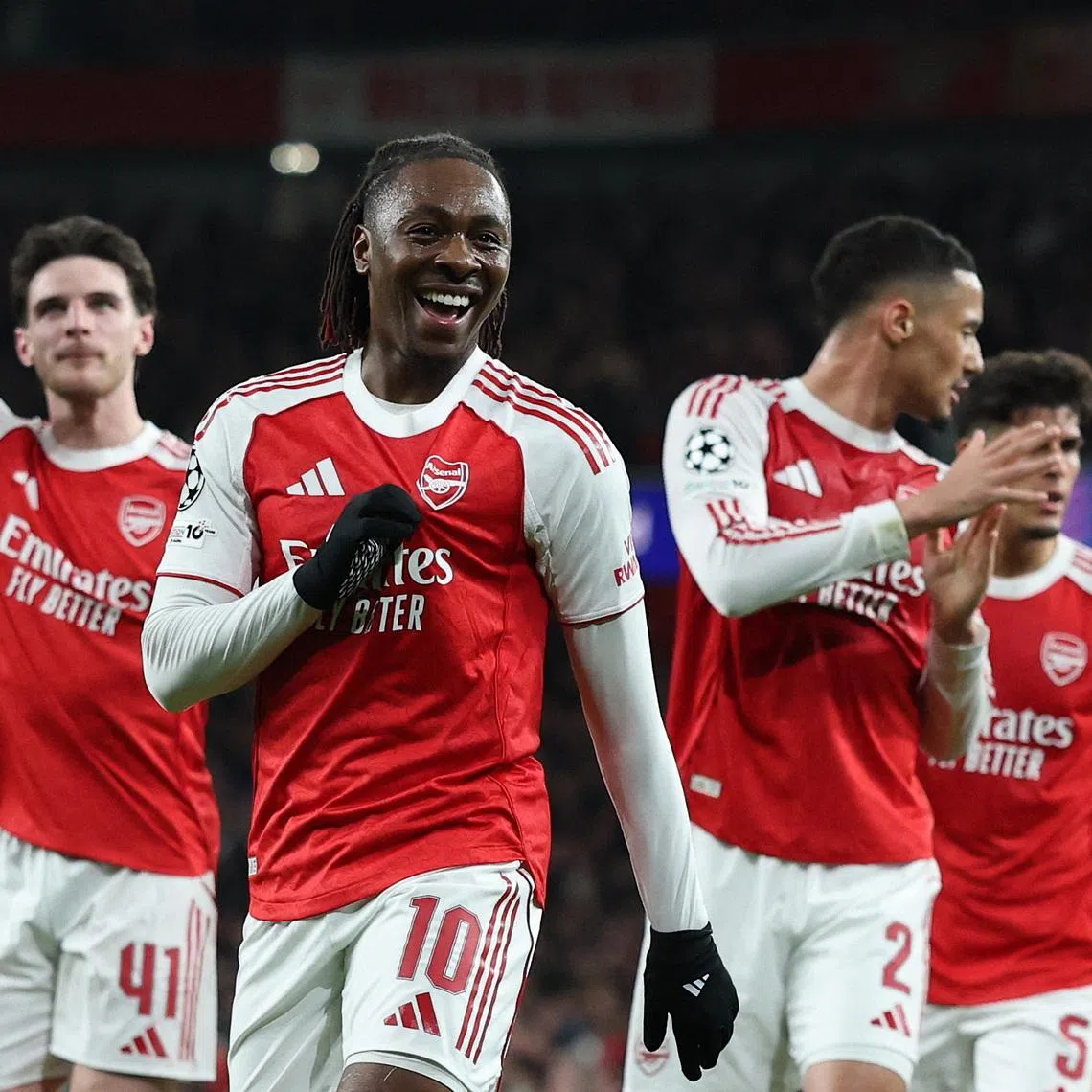 Arsenal's Eberechi Eze celebrates scoring their first goal with Declan Rice and William Saliba.