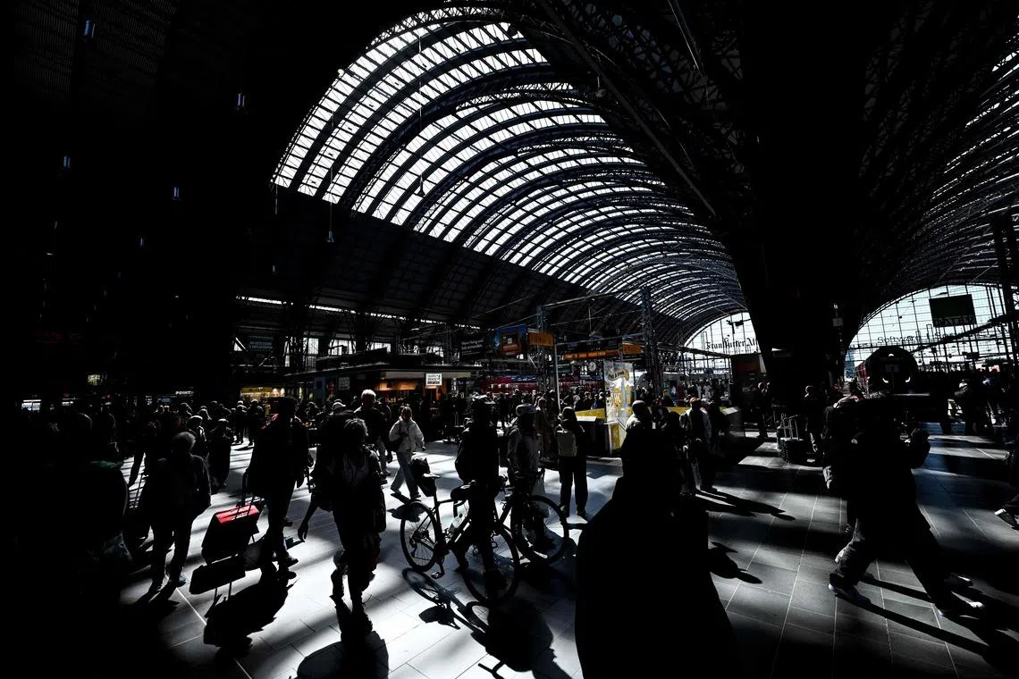 Passengers walking on a platform at the main railway station in Frankfurt, Germany, on April 7, 2026. 