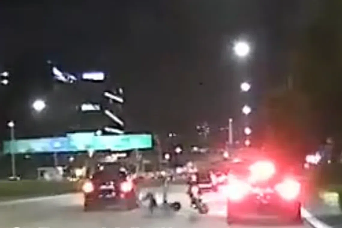 A video posted on Facebook shows a dark-coloured car driving next to a motorcycle.