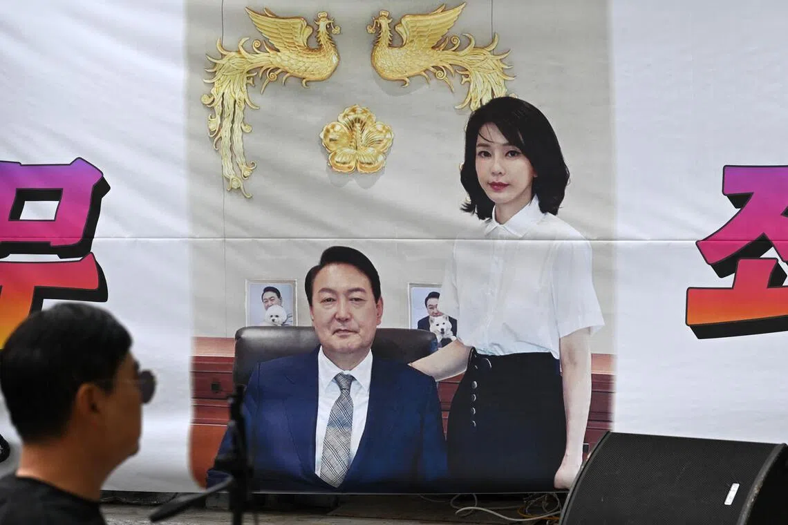 A banner showing a picture of South Korea's former president Yoon Suk Yeol and his wife Kim Keon Hee on a street near the Seoul High Court.
