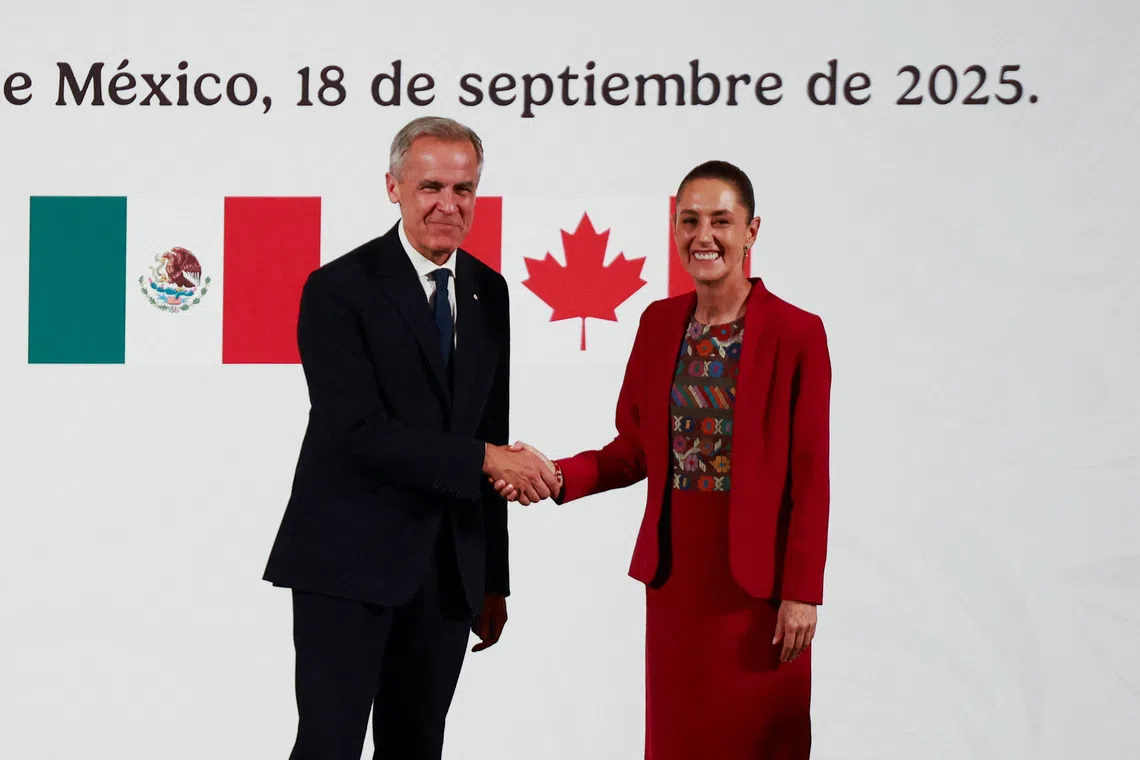 Mexican President Claudia Sheinbaum and Canadian Prime Minister Mark Carney shake hands as they hold a press conference at the National Palace, in Mexico City, Mexico September 18, 2025. REUTERS/Raquel Cunha