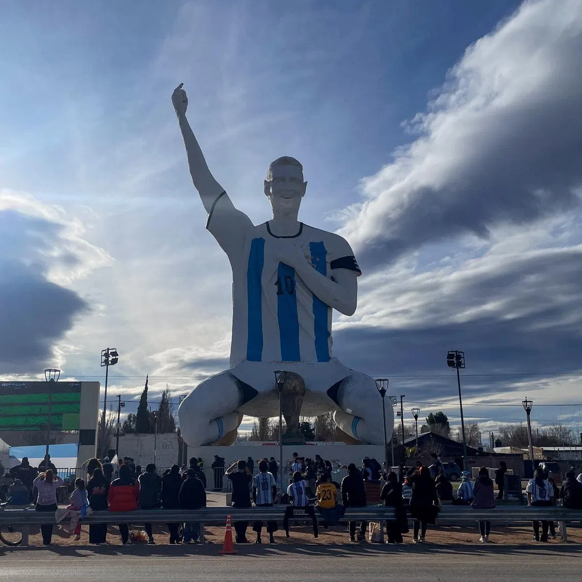People gather by a statue of Argentina's revered Lionel Messi while watching the World Cup semi-final between Argentina and England, in Cutral Co, in the Patagonian province of Neuquen, Argentina, July 15, 2026. REUTERS/Leila Miller
