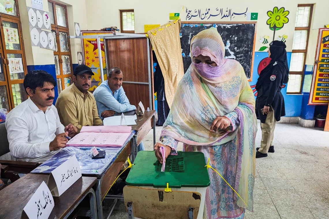 FILE PHOTO: A woman votes during the second phase of the Azad Jammu and Kashmir (AJK) Legislative Assembly elections at a polling station in Muzaffarabad, Pakistan, August 2, 2026. Picture taken with a mobile phone. REUTERS/Stringer/File Photo