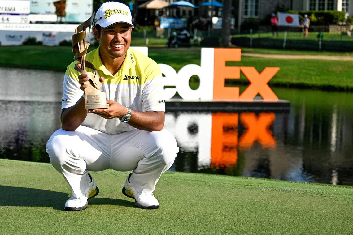 Aug 18, 2024; Memphis, Tennessee, USA; Hideki Matsuyama poses with the FedEx Cup TPC Southwind Champion trophy during the final round of the FedEx St. Jude Championship golf tournament at TPC Southwind. Mandatory Credit: Steve Roberts-USA TODAY Sports