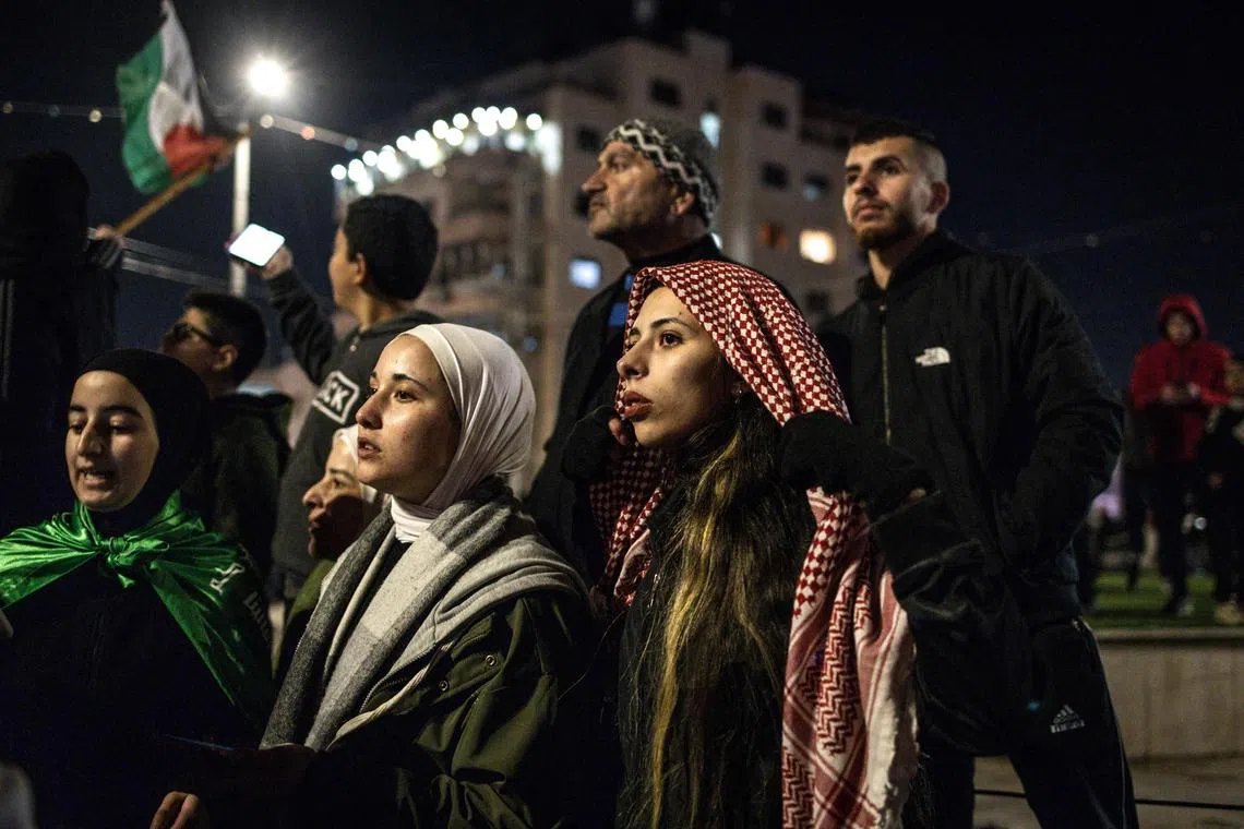 Palestinians family members and friends wait for the release of prisoners held by Israel, in Beitunia, outside the West Bank city of Ramallah, on Jan 19.
