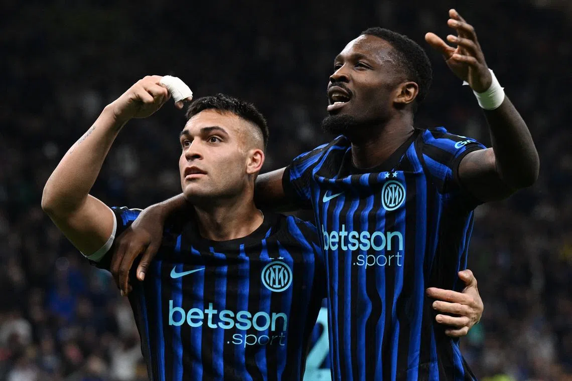 Soccer Football - Serie A - Inter Milan v AS Roma - San Siro, Milan, Italy - April 5, 2026 Inter Milan's Lautaro Martinez celebrates scoring their third goal with Marcus Thuram REUTERS/Jennifer Lorenzini