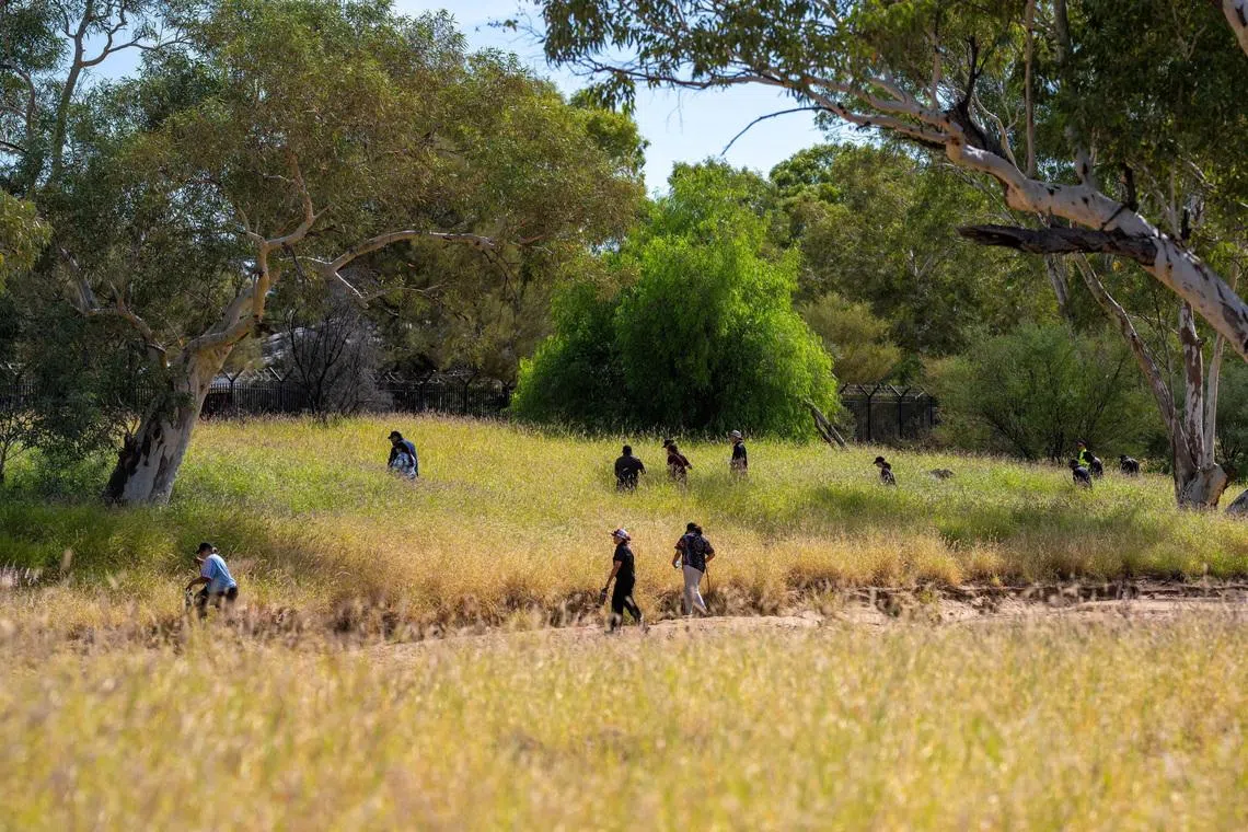 Volunteers join the police and emergency services in searching the scrubland surrounding Todd River on the third day of the search for a missing 5-year-old, whose family has asked her to be referred to as \"Kumanjayi Little Baby\" for cultural reasons, in Alice Springs, Australia, April 28, 2026. AAP/Rhett Hammerton via REUTERS