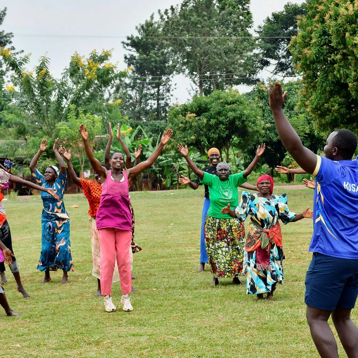 FILE PHOTO: Fitness coach Aaron Kusasira guides elderly women as they take part in community-led fitness drills session that combines yoga, aerobics, and cricket drills to combat non-communicable diseases (NCDs), on a playing field in Kivubuka village, in Jinja District, Eastern Uganda, July 12, 2025. REUTERS/Abubaker Lubowa/File Photo