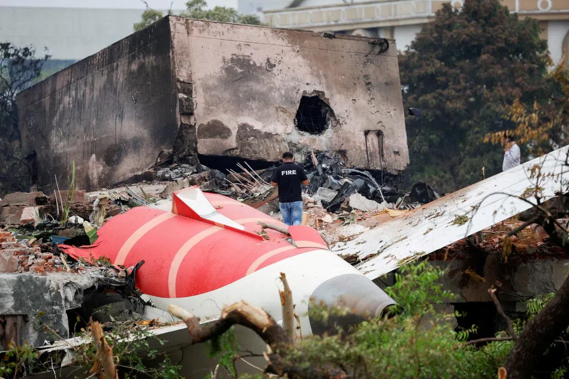 FILE PHOTO: A fire officer stands next to the crashed Air India Boeing 787-8 Dreamliner aircraft, in Ahmedabad, India, June 13, 2025. REUTERS/Adnan Abidi/File Photo