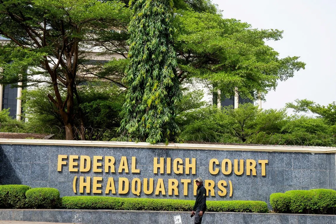 FILE PHOTO: A member of the Nigerian State Security Service walks by the Federal High Court before a hearing of the leader of the proscribed Indigenous People of Biafra (IPOB) Nnamdi Kanu, in Abuja, Nigeria, March 19, 2024. REUTERS/Marvellous Durowaiye/File Photo