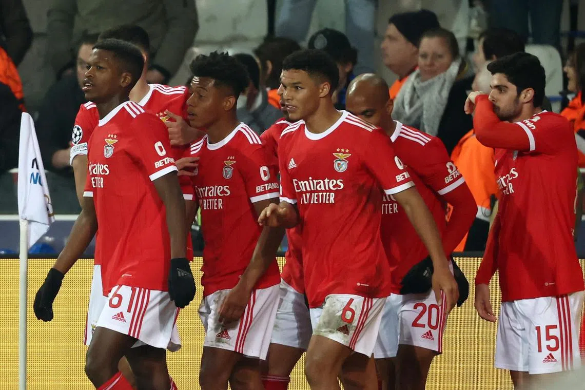 Benfica's David Neres celebrates scoring their second goal with teammates.