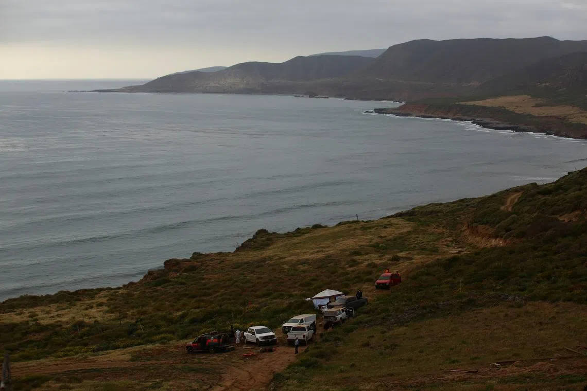 FILE PHOTO: Members of a rescue team and forensic technicians work at a site where three bodies were found in the state of Baja California where one American and two Australian tourists were reported missing, in La Bocana, Mexico May 3, 2024. REUTERS/Jorge Duenes/File Photo