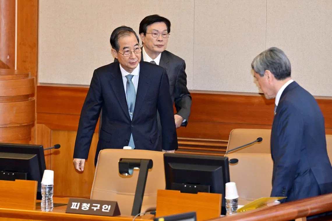 South Korea's ousted premier Han Duck-soo attending the first hearing of his impeachment trial in Seoul on Feb 19.