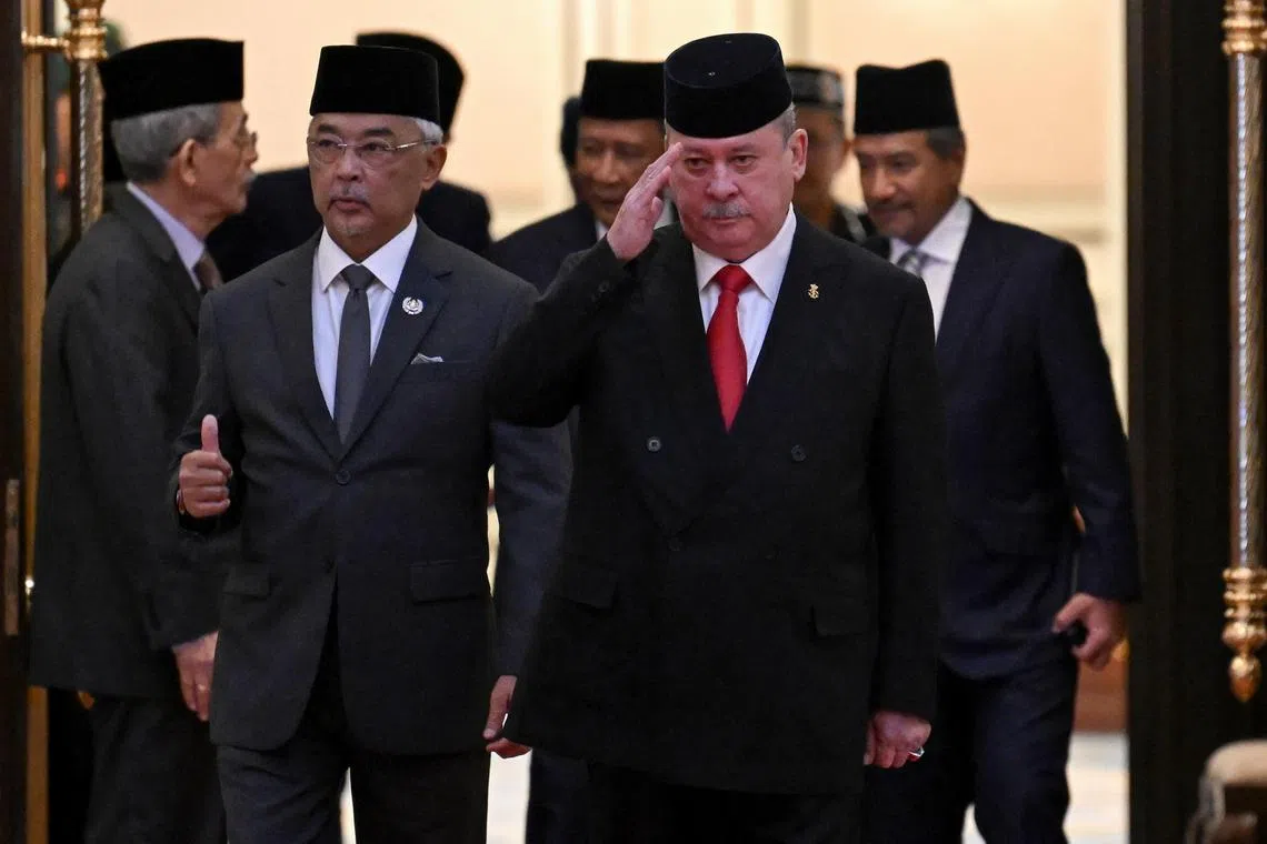 Malaysia's King Sultan Abdullah Ahmad Shah (left) and Sultan Ibrahim Iskandar of Johor (right) walk together after the election for the next Malaysian King at the National Palace in Kuala Lumpur.