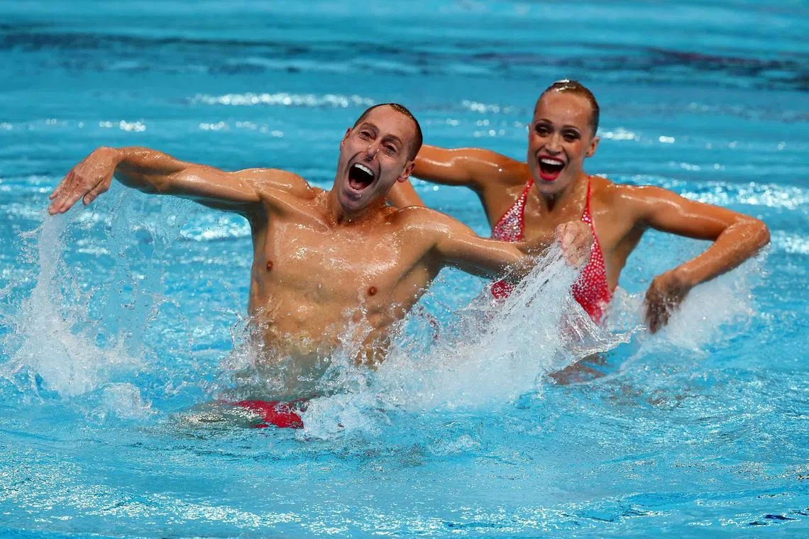 bILL mAYUS synchronised swimming duet Christina Jones and Bill May competes in the Mixed Duet Technical preliminary during the synchronised swimming competition at the 2015 FINA World Championships in Kazan on July 25, 2015.  AFP PHOTO / CHRISTOPHE SIMON (Photo by CHRISTOPHE SIMON / AFP)