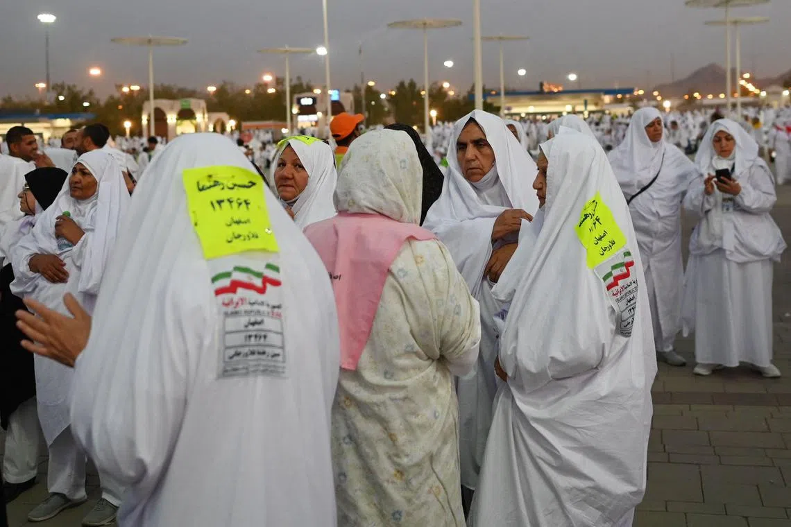Iranian Muslim pilgrims head to Saudi Arabia's Mount Arafat, also known as Jabal al-Rahma or Mount of Mercy, during the climax of the Hajj pilgrimage on June 27, 2023. The ritual is the high point of the annual pilgrimage, one of the five pillars of Islam, that officials say could be the biggest on record after three years of Covid restrictions. (Photo by Sajjad HUSSAIN / AFP)