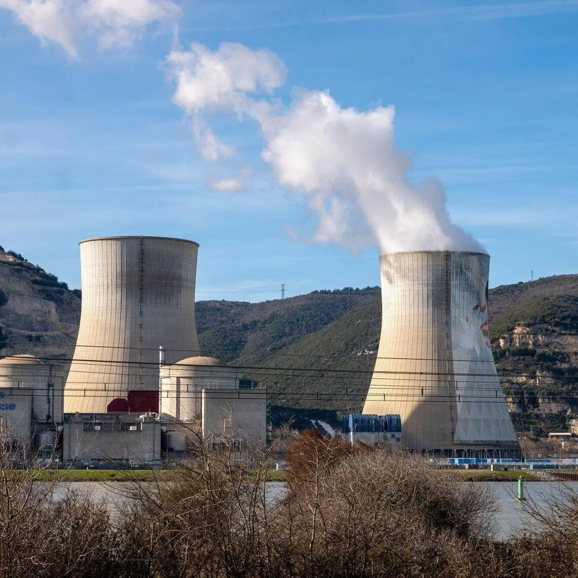 Power transmission lines near the cooling tower of Cruas Nuclear Power Station, operated by Electricite de France SA (EDF), near Montelimar, France, on Wednesday, Feb. 25, 2026. Robust nuclear and hydro availability in France, along with forecasts for higher solar output next month, have pressured prices. Photographer: Jeremy Suyker/Bloomberg