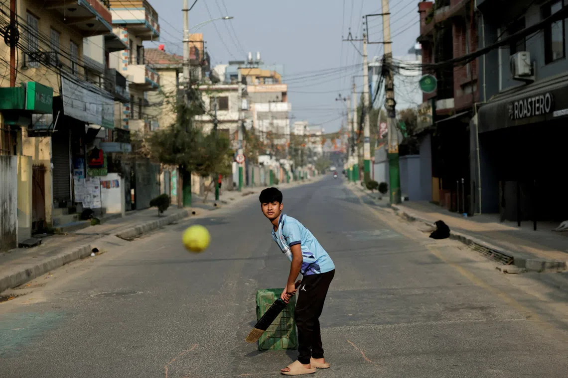 FILE PHOTO: A boy plays cricket on an empty road during the general election in Lalitpur, Nepal, March 5, 2026. REUTERS/Navesh Chitrakar/File Photo