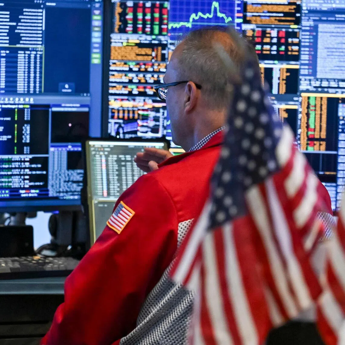Traders working on the floor of the New York Stock Exchange at the closing bell, in New York City, on July 23.