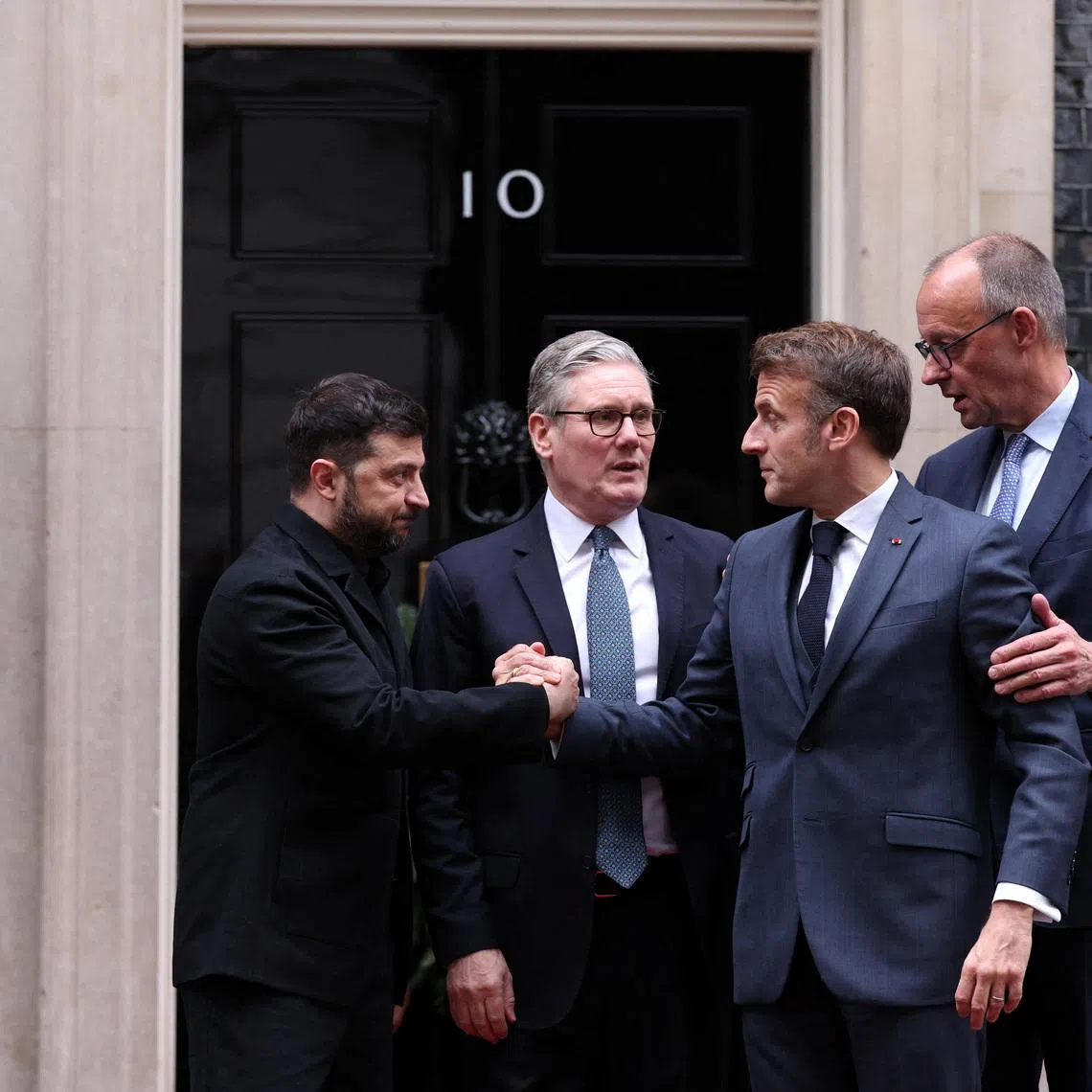 British Prime Minister Keir Starmer, Ukrainian President Volodymyr Zelenskiy, French President Emmanuel Macron, and German Chancellor Friedrich Merz chat outside 10 Downing Street following a meeting, in London, Britain, December 8, 2025.  ADRIAN DENNIS/Pool via REUTERS