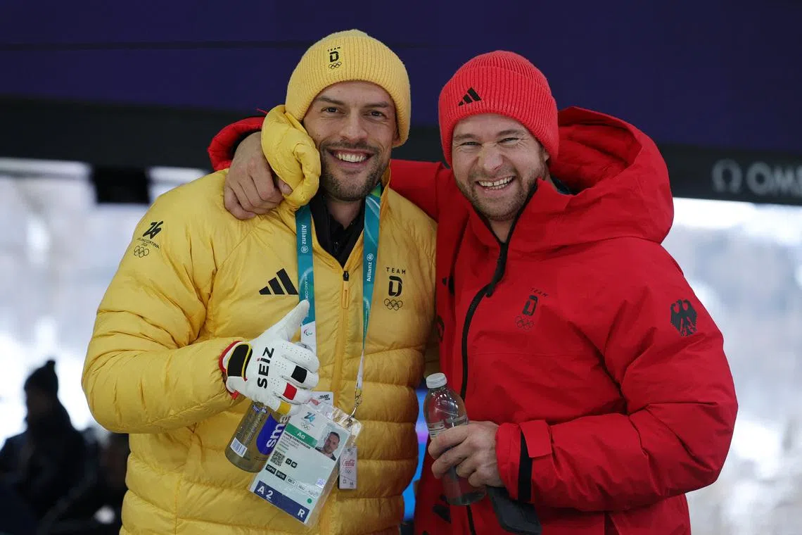 Milano Cortina 2026 Olympics - Bobsleigh - 2-man Heat 2 - Cortina Sliding Centre, Cortina d'Ampezzo, Italy - February 16, 2026. Johannes Lochner of Germany and Georg Fleischhauer of Germany react after their run. REUTERS/Athit Perawongmetha
